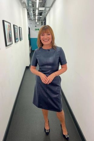 Stepping out in style: Lorraine poses in the studio corridor in a cute mini dress